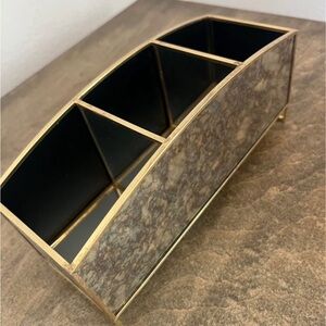 Antiqued mirror with brass colored trim storage container/organizer.